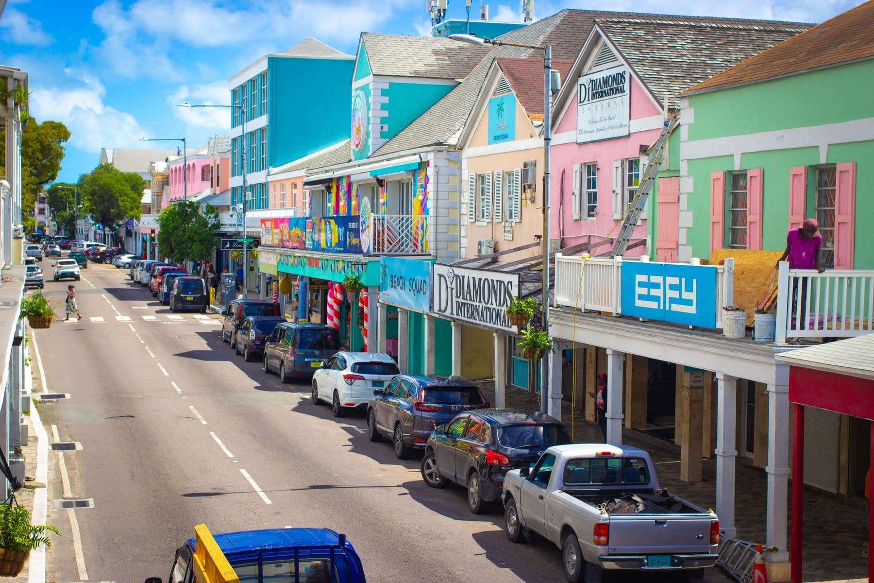 Pastel two-storey shopfronts with balconies on Bay Street, Downtown Nassau